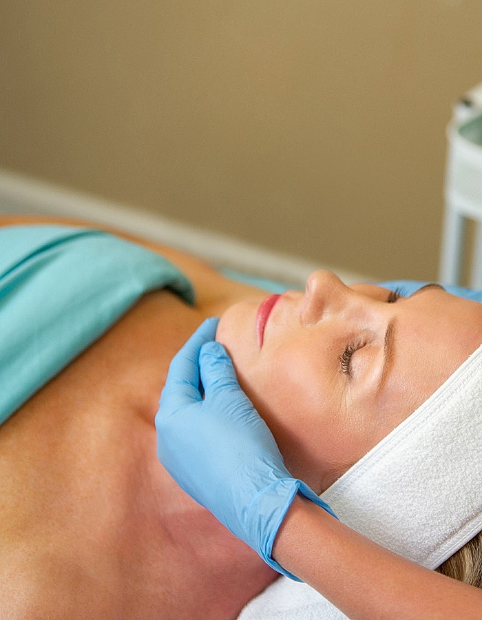 Woman receiving a facial treatment in spa.