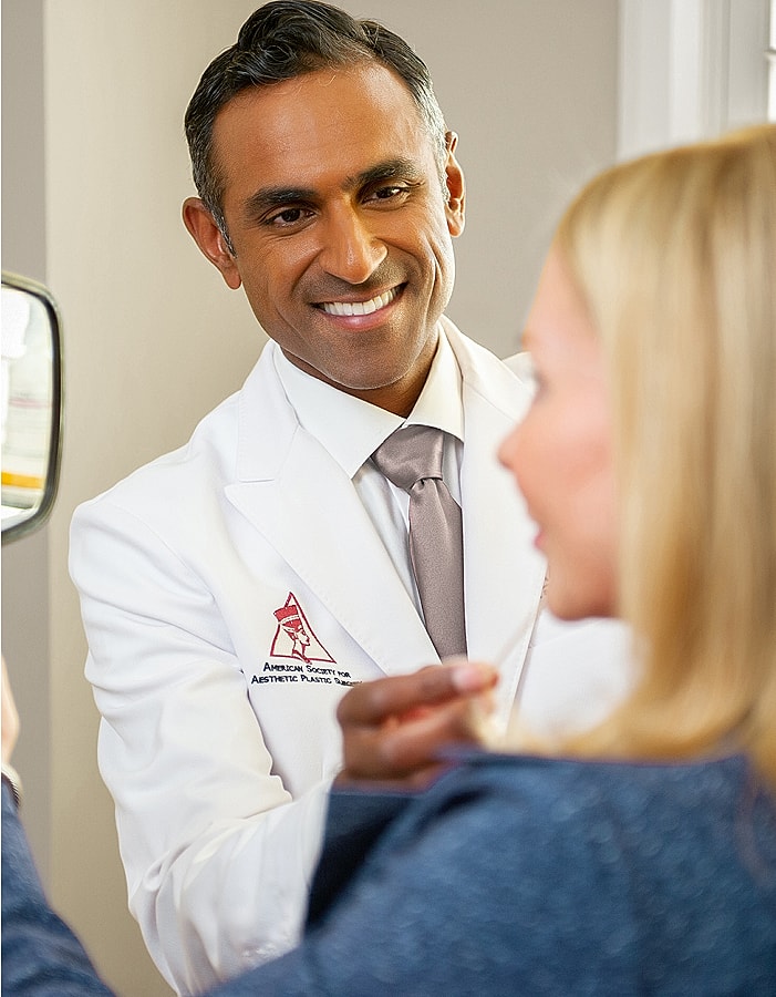 Doctor consulting with patient in aesthetic practice.